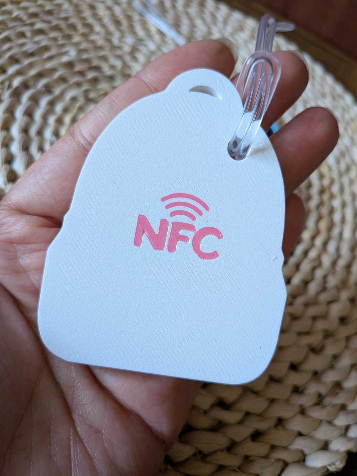 Back of white and pink emergency contact bag tag with pink NFC symbol