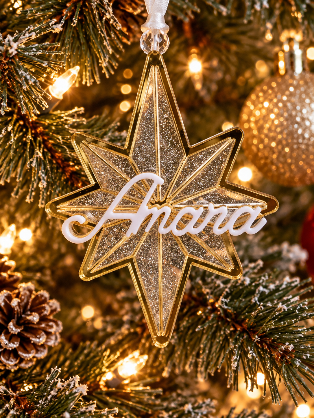 Personalized three-layer glitter acrylic star Christmas ornament hanging on a Christmas tree